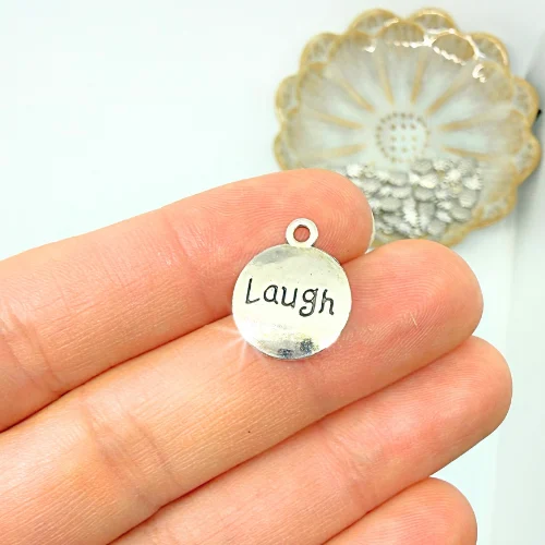 Gravírozott ezüstszínű charm "Laugh" felirattal